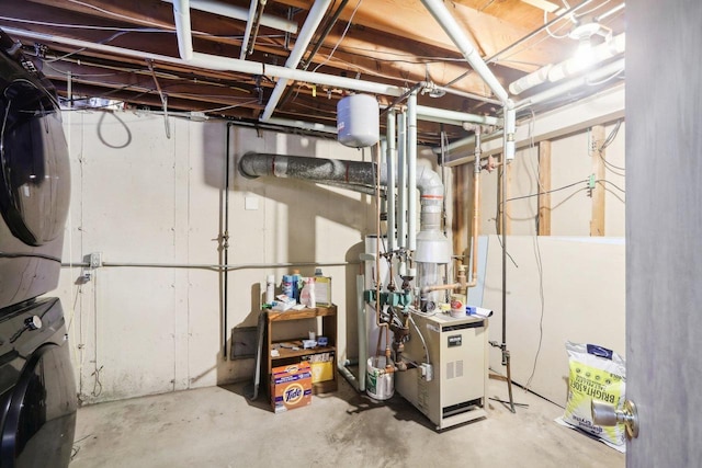 basement featuring stacked washer / dryer