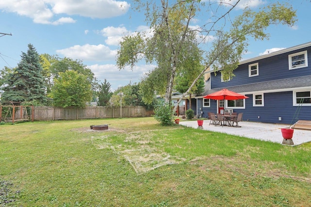 view of yard with a patio and an outdoor fire pit