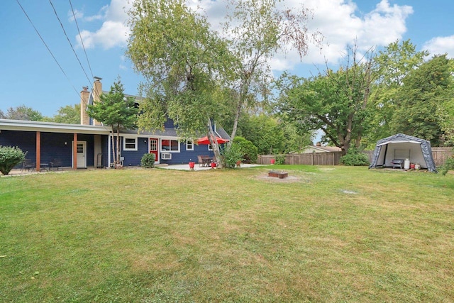 view of yard with a storage shed, a patio area, and a fire pit