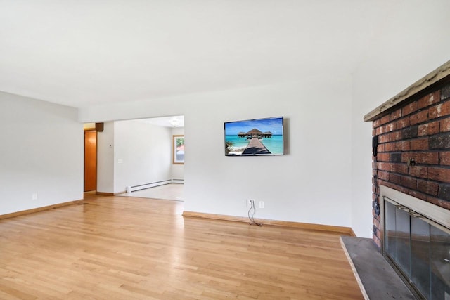 unfurnished living room with light wood-type flooring, baseboard heating, and a fireplace