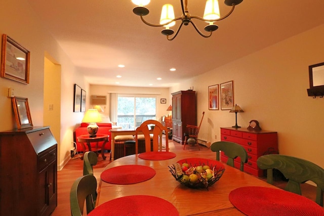 dining space with a notable chandelier and light hardwood / wood-style flooring