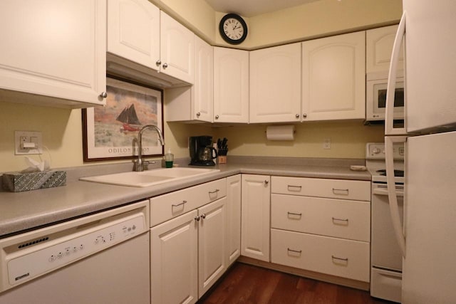 kitchen with white appliances, white cabinetry, sink, and dark hardwood / wood-style flooring