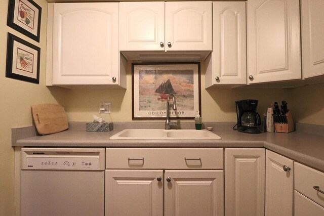 kitchen with white cabinets, dishwasher, and sink