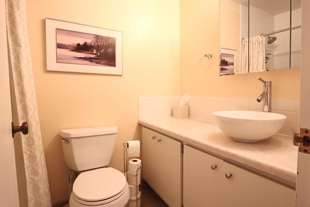 bathroom with vanity, toilet, and walk in shower