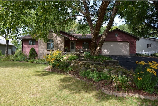 single story home featuring a garage and a front lawn