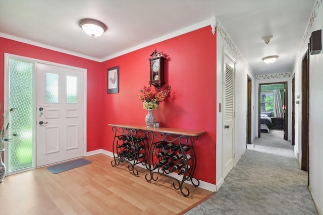 foyer with hardwood / wood-style flooring and ornamental molding