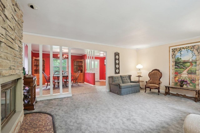 living room with a chandelier, crown molding, carpet floors, and a fireplace