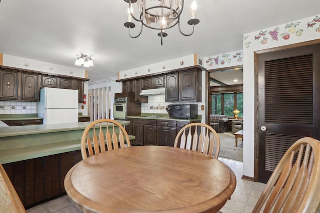 dining space with an inviting chandelier