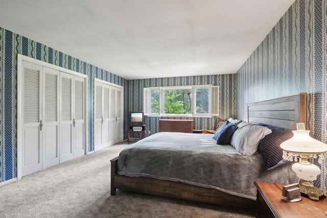 bedroom featuring multiple closets and carpet flooring