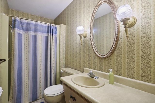 bathroom featuring toilet and vanity