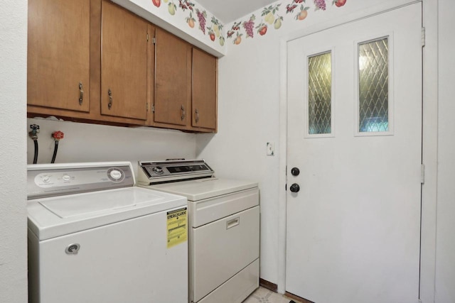 laundry room featuring cabinets and washing machine and dryer