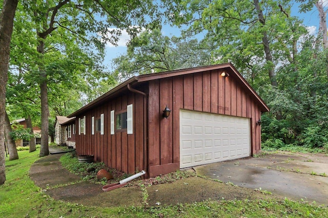 view of side of home featuring a garage and an outbuilding