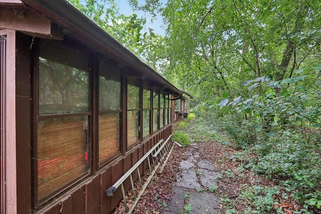 view of property exterior with a sunroom