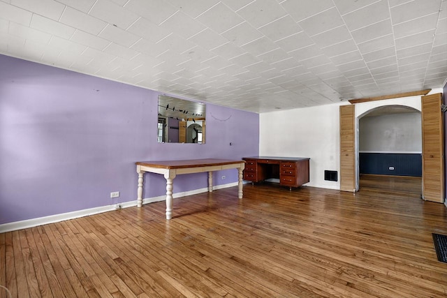 unfurnished living room with hardwood / wood-style flooring