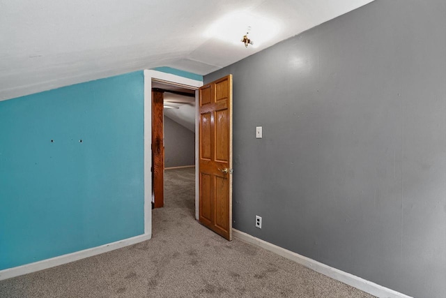 interior space with vaulted ceiling and carpet floors