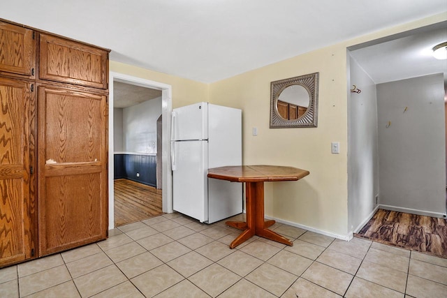 kitchen featuring white refrigerator and light hardwood / wood-style floors