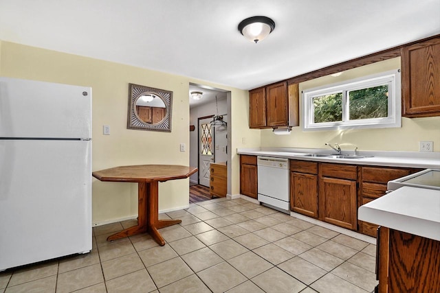 kitchen featuring light tile patterned floors, sink, and white appliances