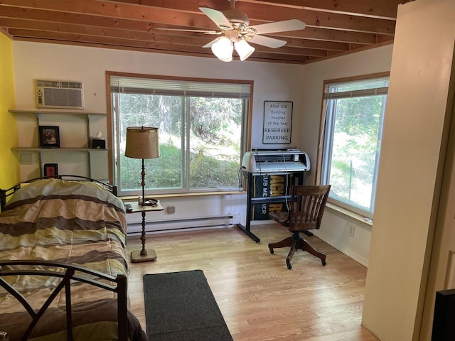 bedroom featuring light hardwood / wood-style floors, a baseboard heating unit, beamed ceiling, a wall mounted air conditioner, and ceiling fan