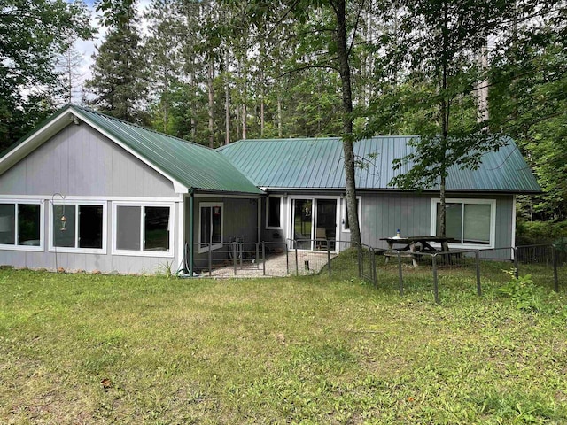 rear view of house featuring a lawn