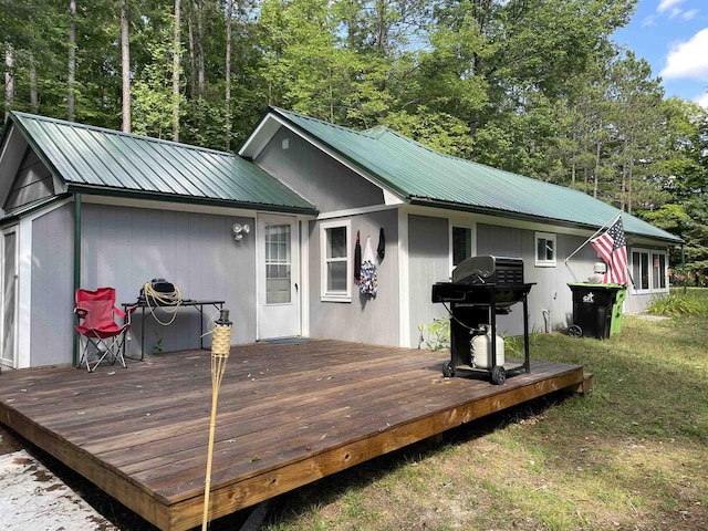 wooden deck featuring a grill