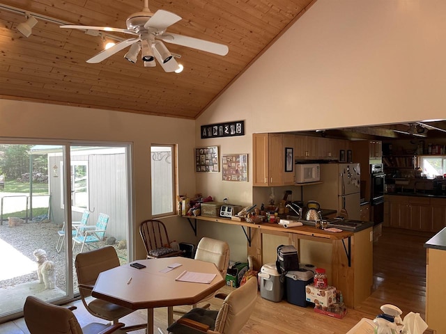 dining space with wooden ceiling, high vaulted ceiling, light wood-type flooring, and ceiling fan