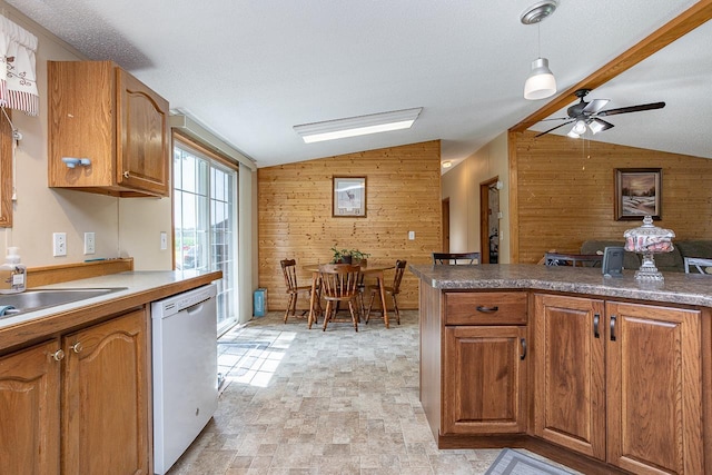 kitchen with ceiling fan, dishwasher, wooden walls, and light tile patterned flooring