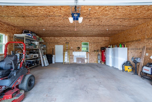 garage featuring a garage door opener and white fridge