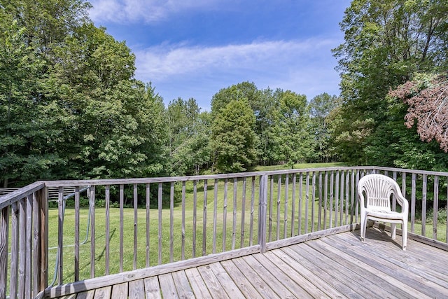 wooden terrace featuring a lawn