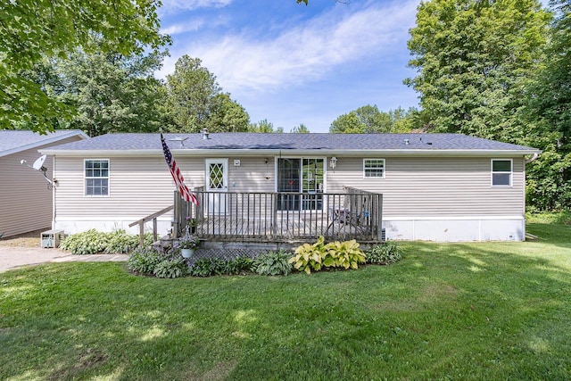 view of front of property with a front lawn, a deck, and cooling unit