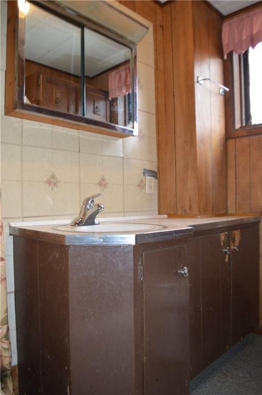 bathroom with decorative backsplash and sink