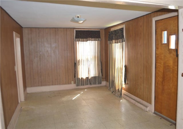 empty room featuring wood walls