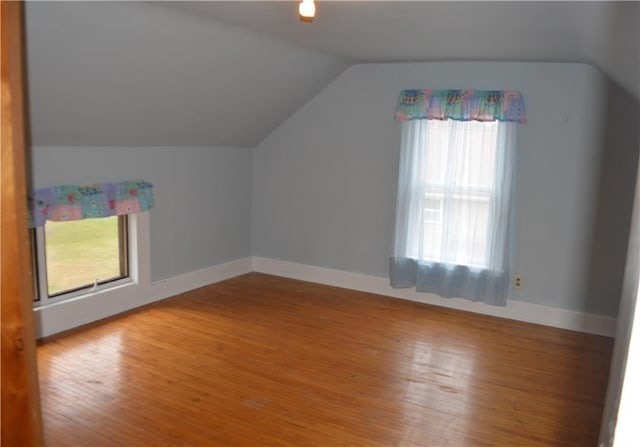 bonus room with lofted ceiling and hardwood / wood-style floors