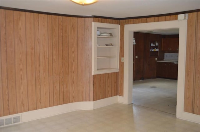 spare room featuring wood walls