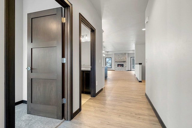 hallway with light hardwood / wood-style floors