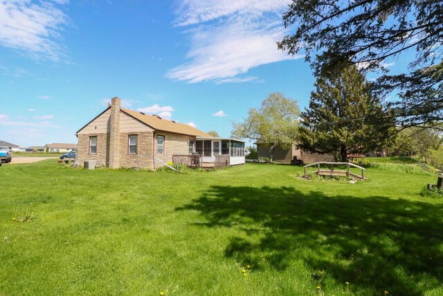 view of yard with a deck and a sunroom