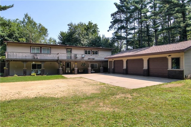 back of house featuring a garage and a lawn