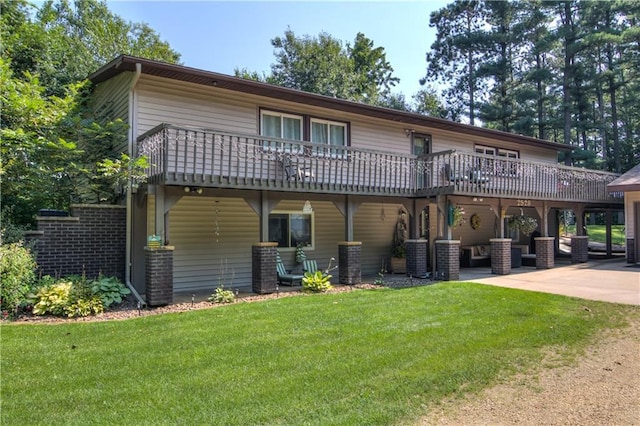 back of house with a patio, a lawn, and a wooden deck