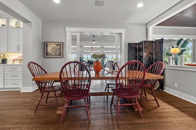 dining room with dark hardwood / wood-style flooring