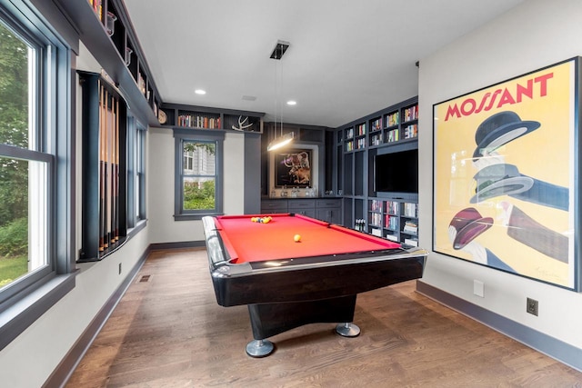 recreation room featuring a wealth of natural light, hardwood / wood-style floors, and pool table