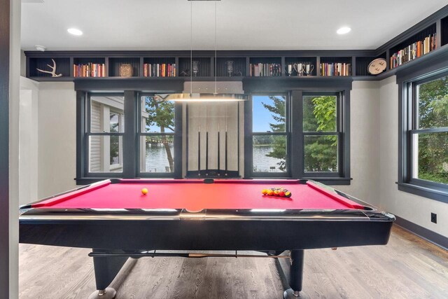 playroom featuring plenty of natural light, light hardwood / wood-style floors, and pool table