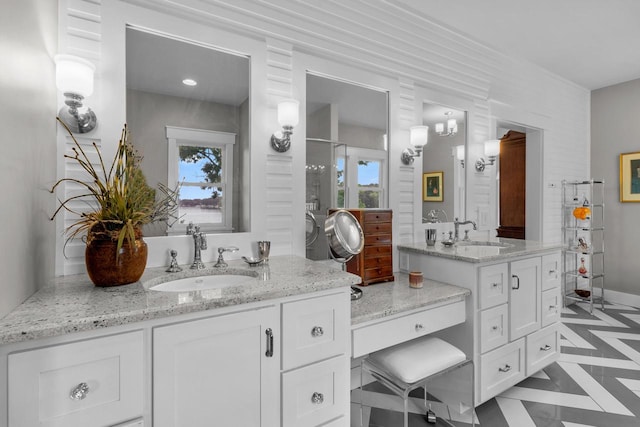 bathroom featuring vanity and a shower with door