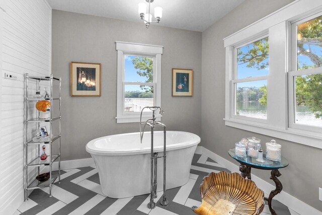 bathroom with a wealth of natural light and tile patterned flooring