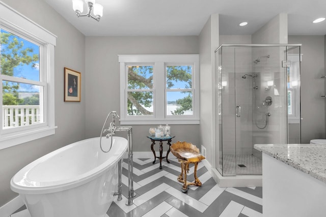 bathroom featuring tile patterned floors, separate shower and tub, and vanity