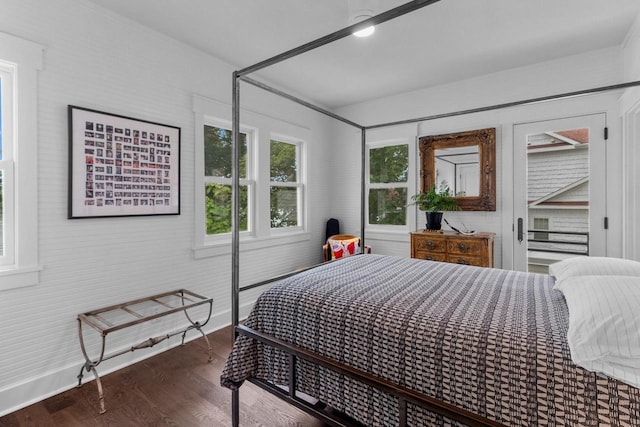 bedroom with dark hardwood / wood-style flooring