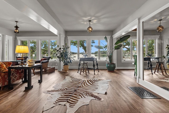 sunroom / solarium featuring plenty of natural light and ornate columns