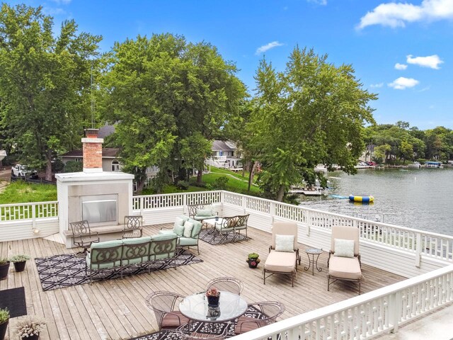 wooden deck featuring exterior fireplace