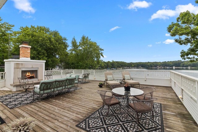 view of patio / terrace featuring a deck and an outdoor living space with a fireplace