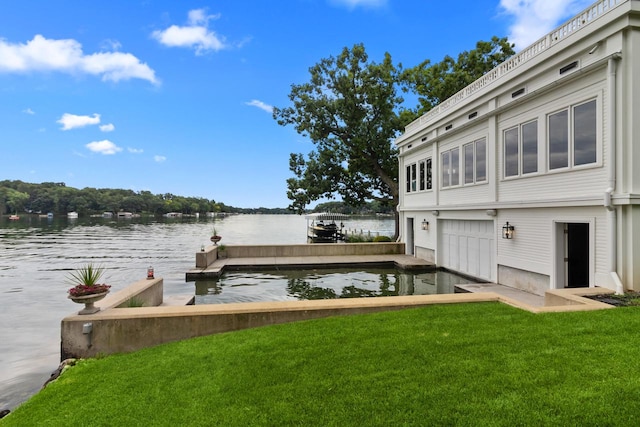 view of dock featuring a water view and a yard