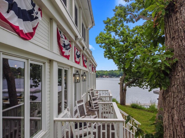 deck featuring a dock and a water view