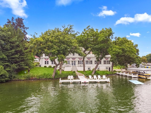 view of dock featuring a yard and a water view